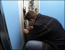 mechanic repairing button in the lift located in a residential building